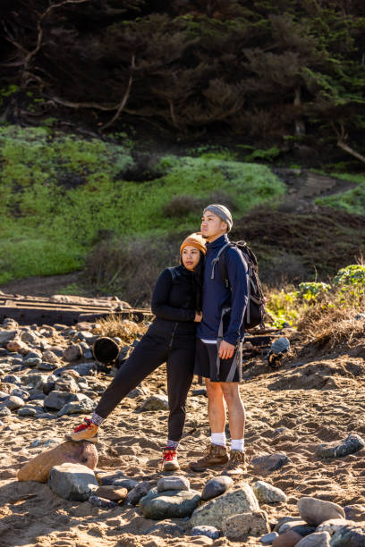 istock Young Couple Hiking Along Coast 1356705640