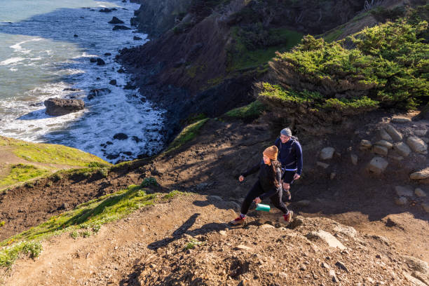 istock Young Couple Hiking Along Coast 1356705658