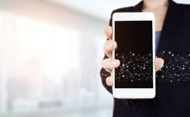 istock Automation Software Technology Process System Business concept. Hand hold white smartphone with digital hologram wave sign on light blurred back. Innovative, global network , Data exchanges. 1356709428