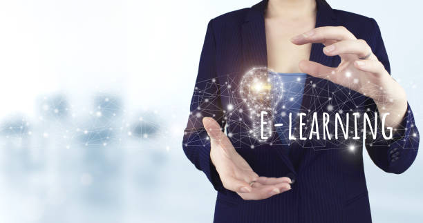 istock Online education. E-learning and e-book concept. Education online learning media. Two hand holding virtual holographic light bulb, e-learning icon. E-learning Education Webinar Online Courses. 1356709440
