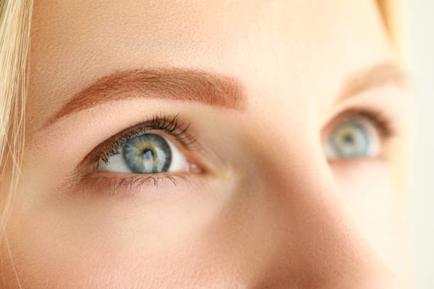 Close up of young female in beauty salon. She was having a macro treatment on eyebrows.