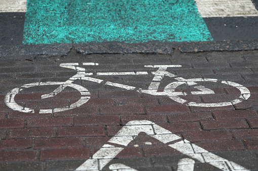Bicycle parking sign painted on paint on asphalt. Bike storage system allows cyclists keep your bikes safe and in order. Organizing public spaces and increasing the attractiveness cycling