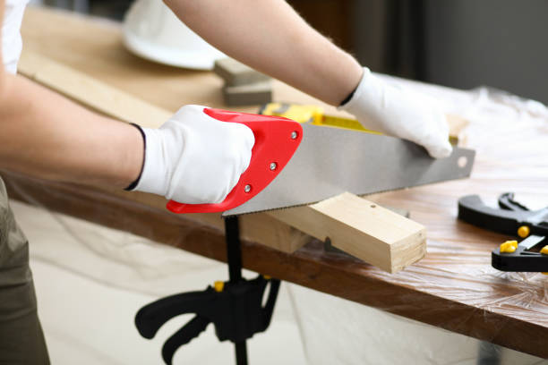 istock Carpenter uses saw which is sawing across at angle 1356711208
