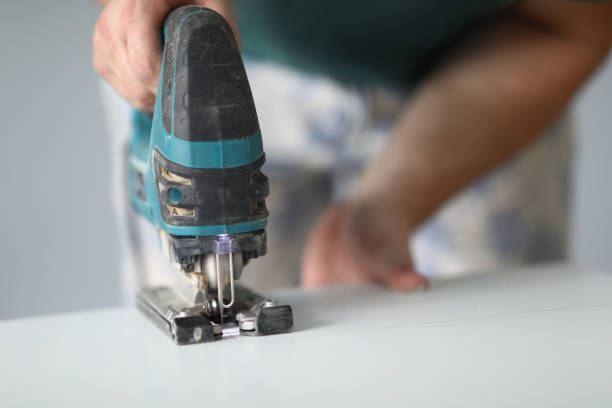 istock Close-up of qualified worker using electrical instrument for work with wood 1356711225