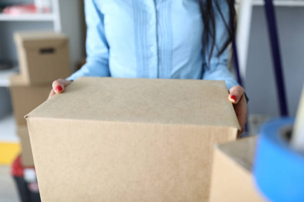 istock Close-up of woman carrying package with personal stuff 1356711232