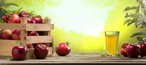 istock Apple juice on wooden table 1356716606