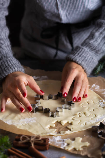 istock Christmas cooking and baking, female hands making cookies from dough 1356718138