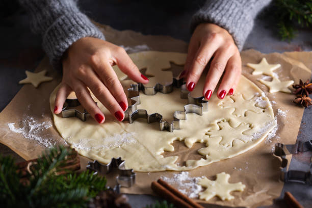 istock Christmas cooking and baking, female hands making cookies from dough 1356718254