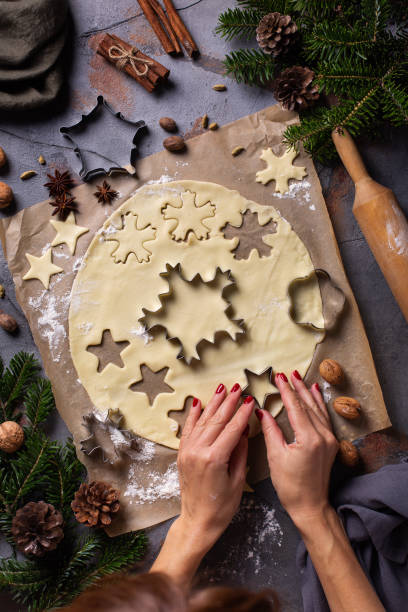 istock Christmas cooking and baking, female hands making cookies from dough 1356719095