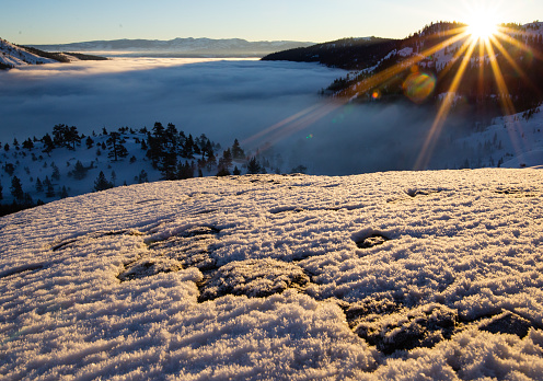A winter sunrise over the Truckee valley and Donner Pass. A foggy and cold landscape