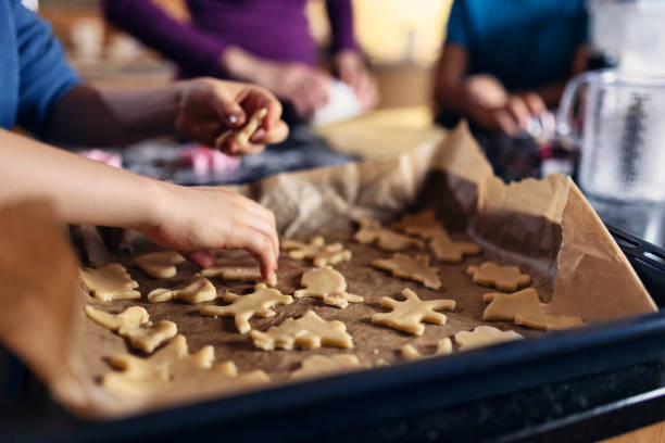 kids making cookies in kitchen - pastry cutter family holiday child imagens e fotografias de stock