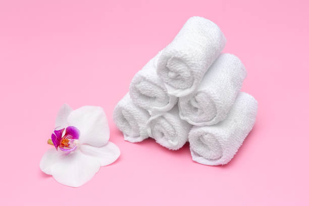 istock white cotton towels on a pink background with a flower 1356720360