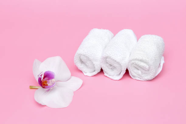 istock white cotton towels on a pink background with a flower 1356720397