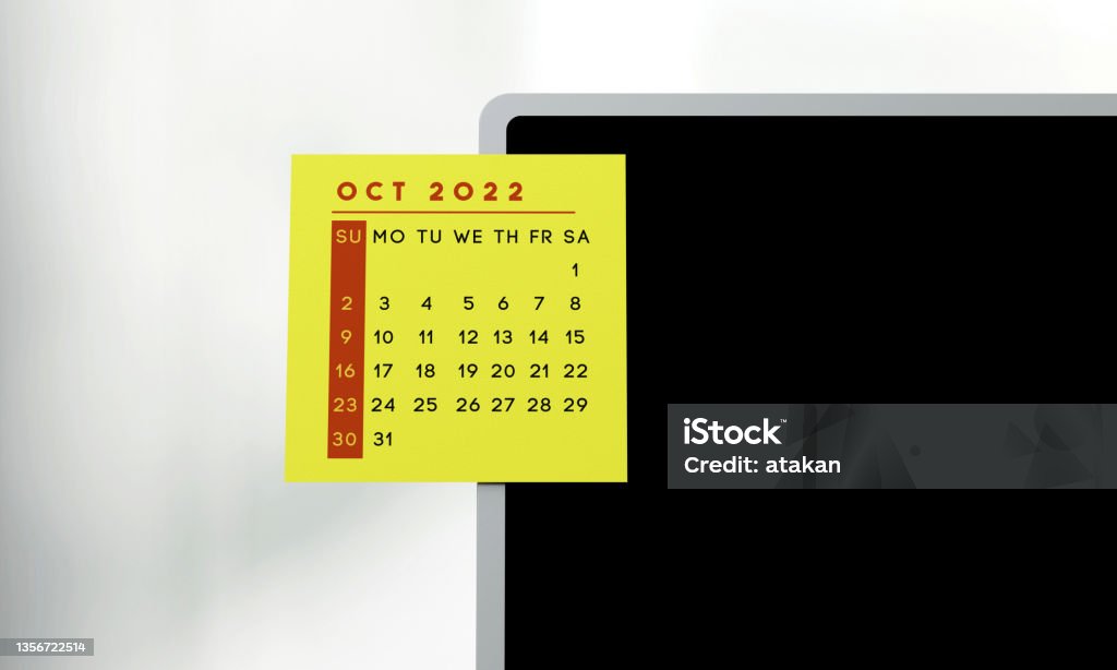 2022 October calendar on the sticker on the laptop screen. 2022 October calendar on the sticker on the blank laptop screen. Planning and organization concept. 2022 Stock Photo