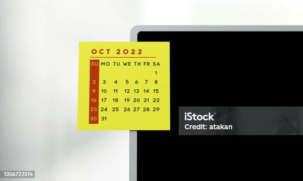 2022 October Calendar On The Sticker On The Laptop Screen Stock Photo - Download Image Now