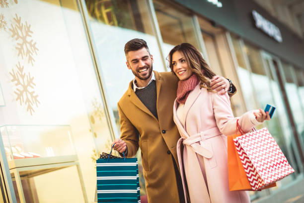Beautiful couple shopping with a credit card in the city stock photo