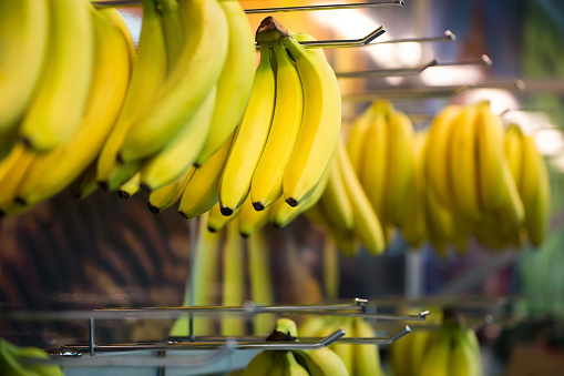 Bananas hanging for sale at the supermarket