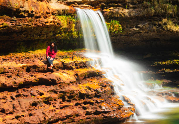 istock waterfall flowing streams falling from mountain top in green forests at morning from low angle 1356726176