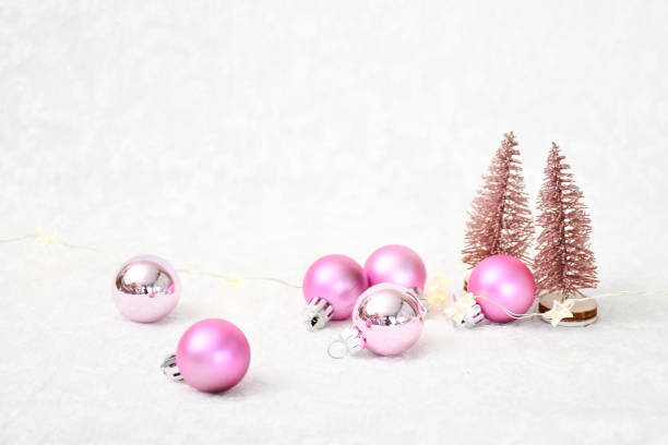 istock Object decorated christmas background, pink christmas ball and small gilter pine trees on white fur with blackground with space for text. .Holiday concept. 1356727821