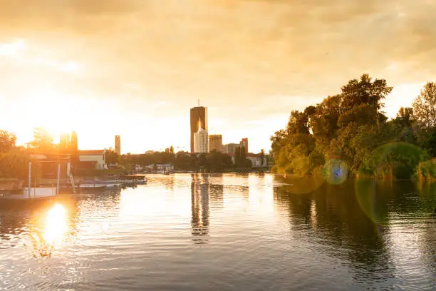 Vienna in summer. Romantic Sunset at the Alten Donau with view to the Skyline. Scenic panorama of the capital city of Austria.