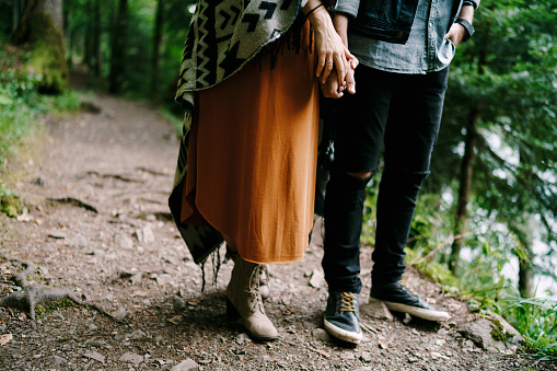 Man and woman are standing on a trail in the forest. Close-up. High quality photo