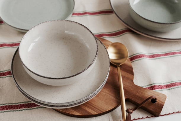 istock Modern ceramic tableware top view on beige table with copy space.  Trendy plates, cutlery and linen napkins scandinavian style. 1356729052
