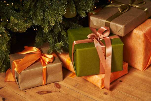 istock christmas gifts in beautiful boxes close-up under a decorated christmas tree 1356730468
