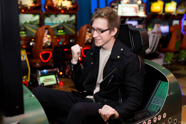 istock Man playing on slot machines, attractions in the mall 1356732373