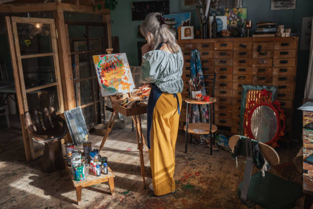 istock Elderly female successful painter drawing something with acrylic palette 1356736992