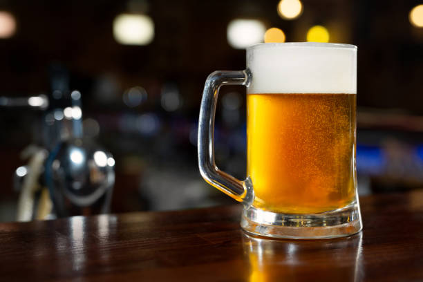 istock Glass of light beer on a dark pub 1356738572