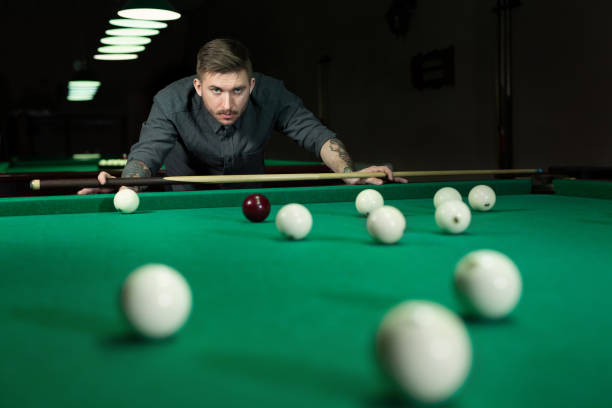 istock Man playing in Russian billiard at bar. 1356738639