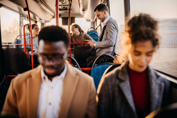 istock Young handsome businessman using phone while riding in a public bus 1356740714