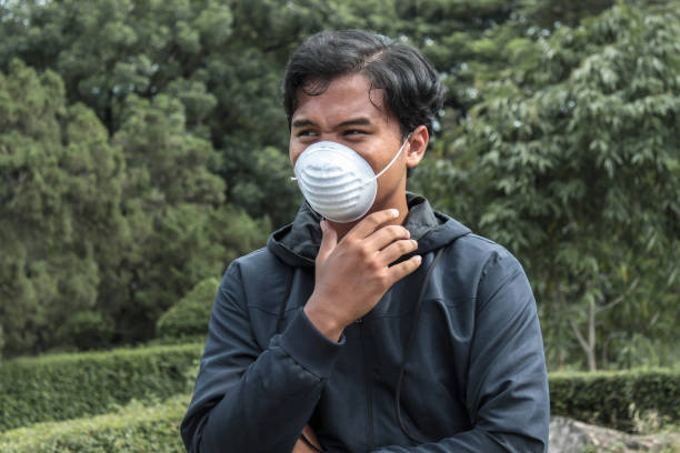 istock Asian man wearing a medical mask 1356740900