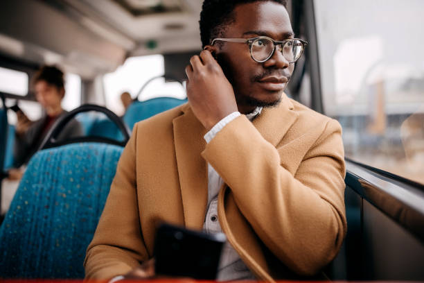 istock Young handsome businessman in public bus 1356741026