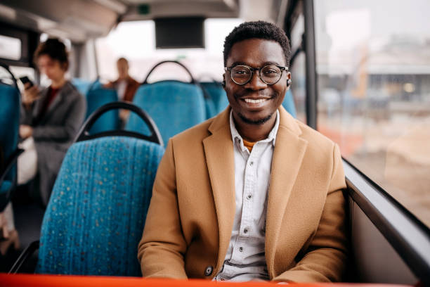 istock Young handsome well dressed man posing in city bus 1356741027