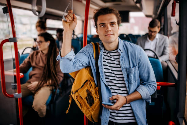 istock Young hipster man in public city bus 1356741417
