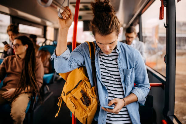 istock Young hipster man in public city bus 1356741443