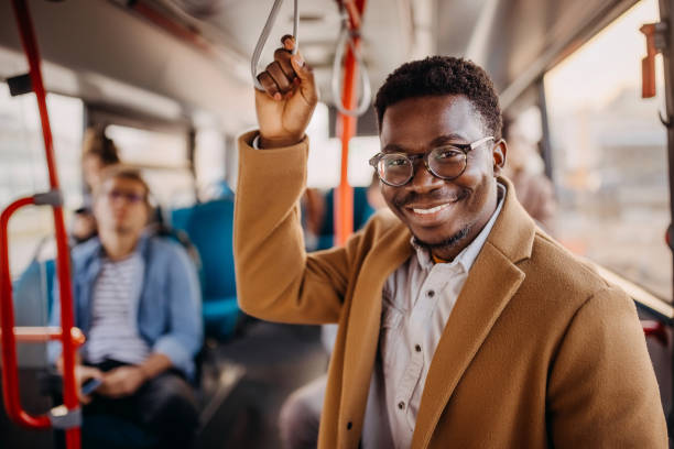 istock Young handsome businessman posing in city bus 1356742175