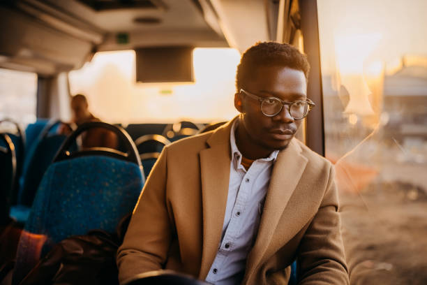 istock Young businessman travelling to work with public buss 1356742515