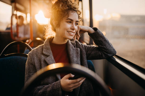 istock Young beautiful woman in public bus 1356742685