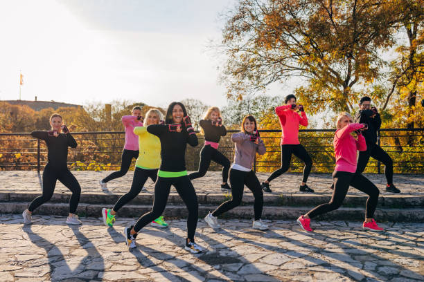 istock Motivated women in group training. They work together to burn fat. 1356742725