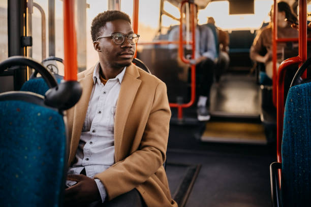 istock Young businessman travelling to work with public buss 1356742767
