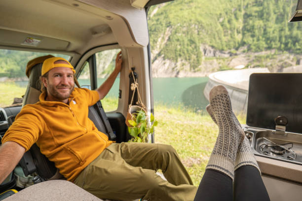 istock Living the van life, young man inside camper van, pov from girlfriend's perspective 1356743513