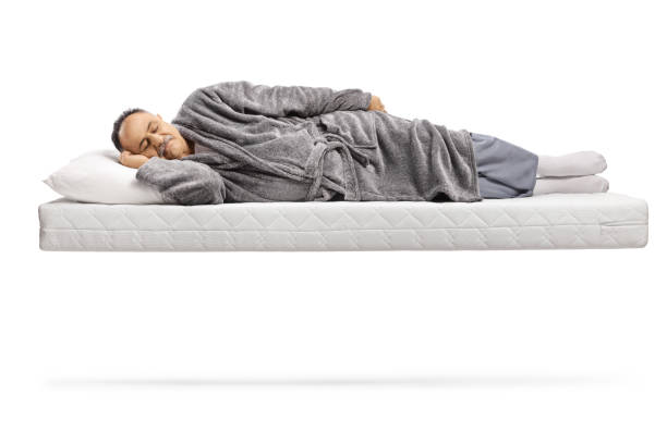 istock Mature man sleeping on a matress and floating 1356743554