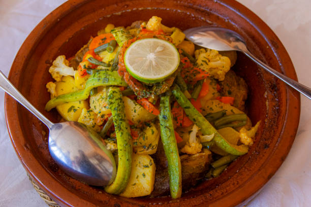 Tajine with vegetables. A tajine or tagine is a North African dish, named after the earthenware pot in which it is cooked. It is also called maraq or marqa.