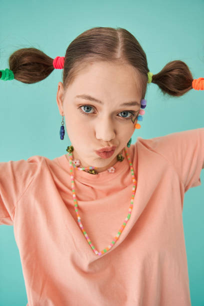 istock Attractive girl with modern hairstyle looking at camera with funny expression 1356744717