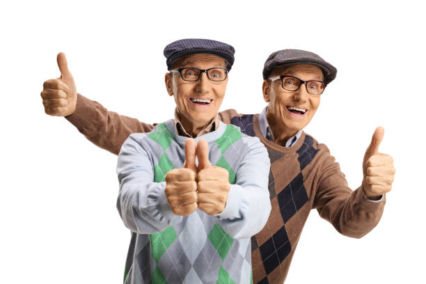 happy elderly male twins showing thumbs up - eeneiige tweeling stockfoto's en -beelden
