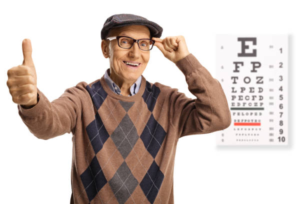 istock Satisfied elderly man with glasses and an eye examination test gesturing thumbs up 1356746038