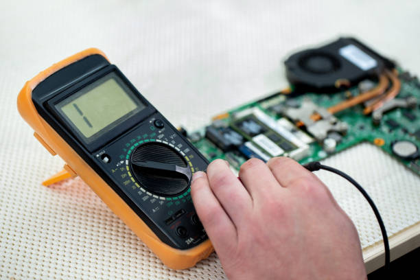 istock Close-up multimeter on the laptop 1356748431