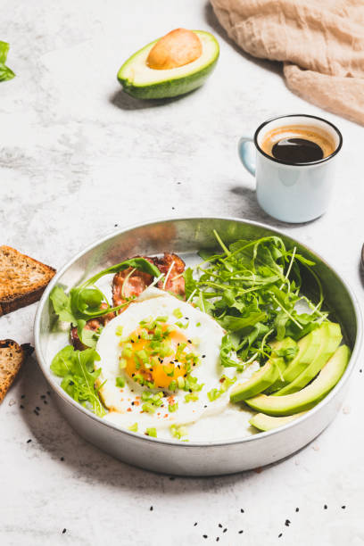 istock Fried eggs sunny side up on baguette, bacon and arugula 1356748716